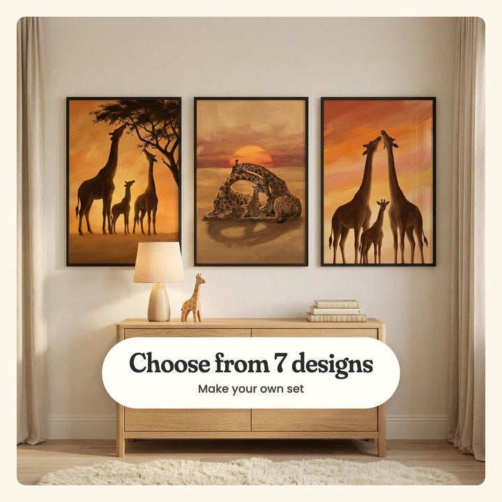 Three giraffe prints in black frames above a light oak dresser with a linen lamp, a wooden toy giraffe and a stack of books, beside linen curtains on a shaggy rug: a giraffe family in silhouette browsing an acacia tree, a giraffe family lying down at sunset and two giraffes touching noses above a calf, labeled Choose from 7 designs, Make your own set