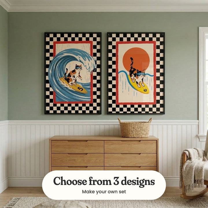 Sage green room with white beadboard panelling and two surfing cat prints in black frames above a light wood dresser with a woven basket, beside a window and a rocking chair with a knit throw: Radical Calico Swell and Radical Calico Surfer, with a label reading Choose from 3 designs, Make your own set