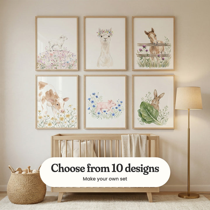 Nursery with six baby farm animal prints in light wood frames in two rows above a light wood crib with a knit throw, beside a woven basket of wooden toys and a brass floor lamp: Sweet Meadow Lamb, Floral Alpaca Portrait, Curious Meadow Foal, Daisy Meadow Calf, Piglet In Flowers and Curious Garden Bunny, with a label reading Choose from 10 designs, Make your own set