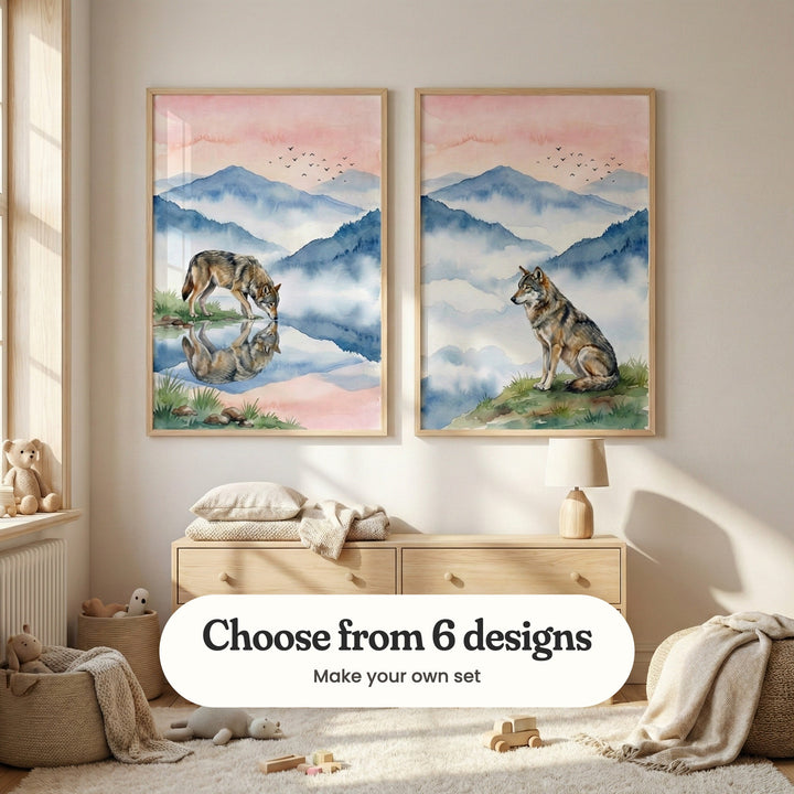 Sunny cream nursery with two wolf prints in light wood frames above a light wood dresser with a lamp, a folded pillow and a throw, beside a basket of teddy bears, a pouf and a shaggy rug with wooden toys: Silent Wolf Reflection and Misty Peak Watcher, with a label reading Choose from 6 designs, Make your own set