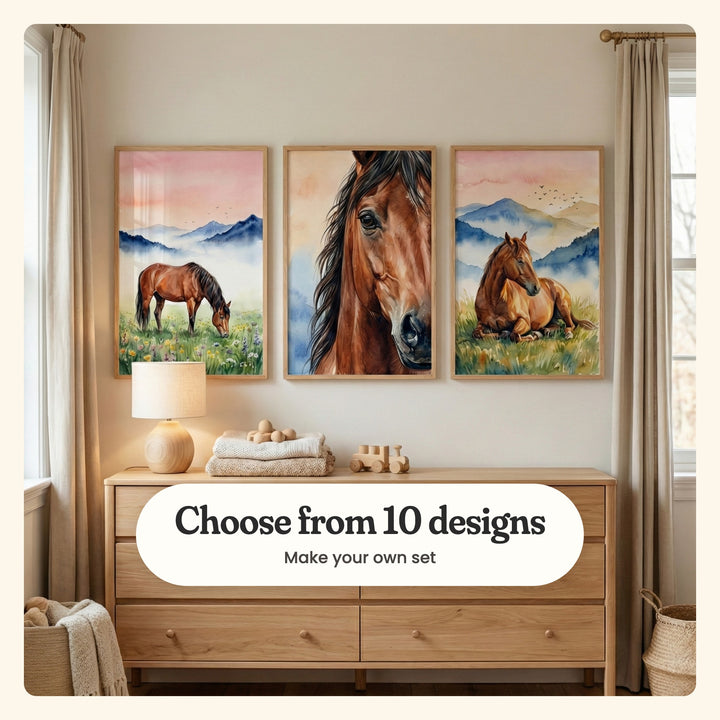 Nursery with three mountain horse prints in light wood frames above an oak dresser with a wooden lamp, folded knit blankets, wooden toys and a toy train, beside linen curtains and woven baskets: a horse grazing in wildflowers, a close-up of a horse's face and a horse resting in golden grass, labeled Choose from 10 designs, Make your own set