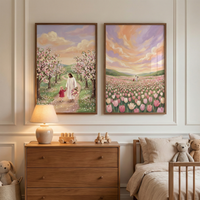 Two framed illustrations hang on a white paneled wall in a cozy nursery. The left artwork shows Jesus walking hand-in-hand with a small child down a path lined with flowering cherry trees. The right artwork depicts a vast field of pink and white tulips under a vibrant sunset sky. Below them sits a light wood dresser with a glowing lamp and wooden toy cars. To the side is a bed with neutral bedding and soft teddy bears, while a plush bunny sits in a basket on the floor.