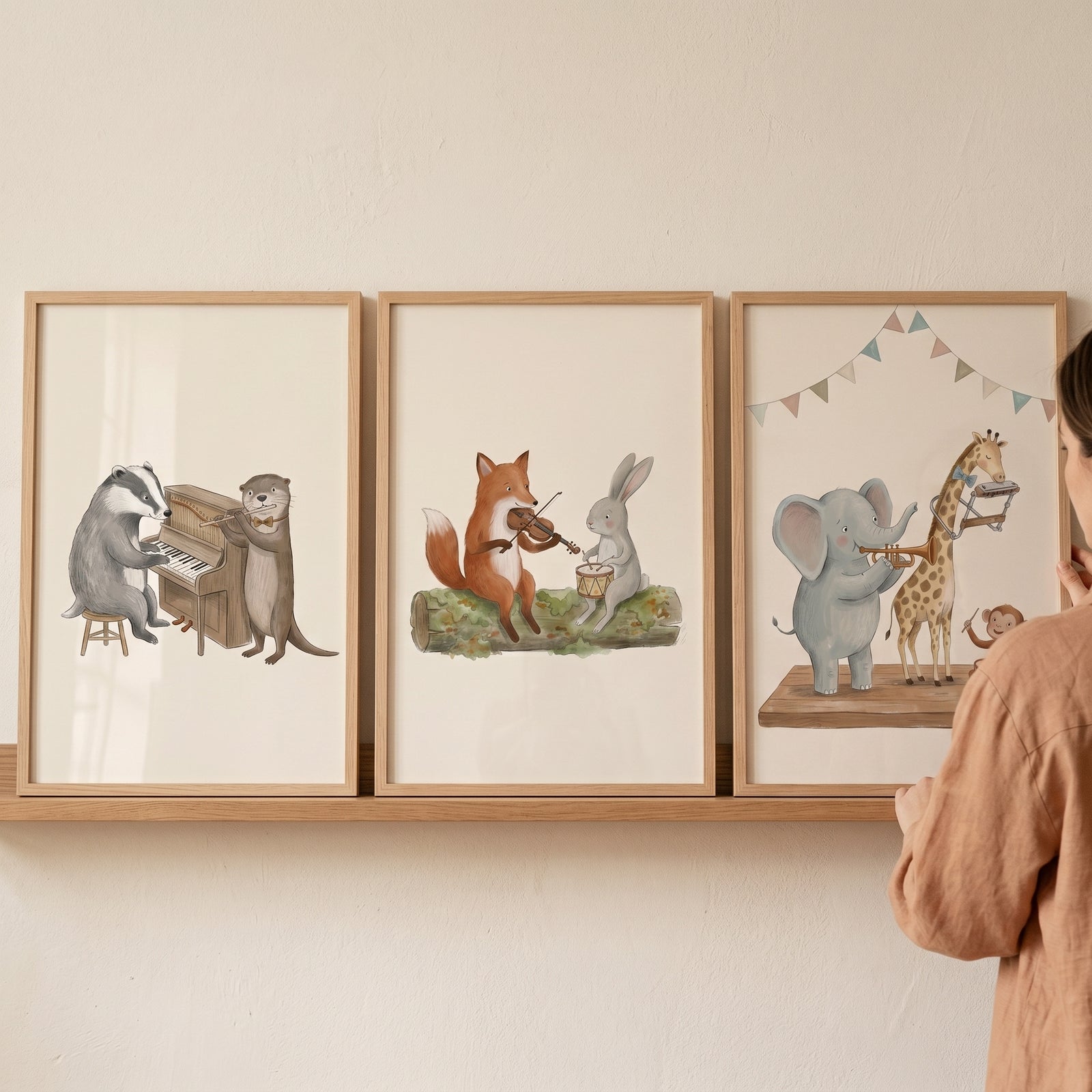 Warm earthy band animals wall art set of 3 on a shelf, featuring a badger, fox, and elephant playing instruments.