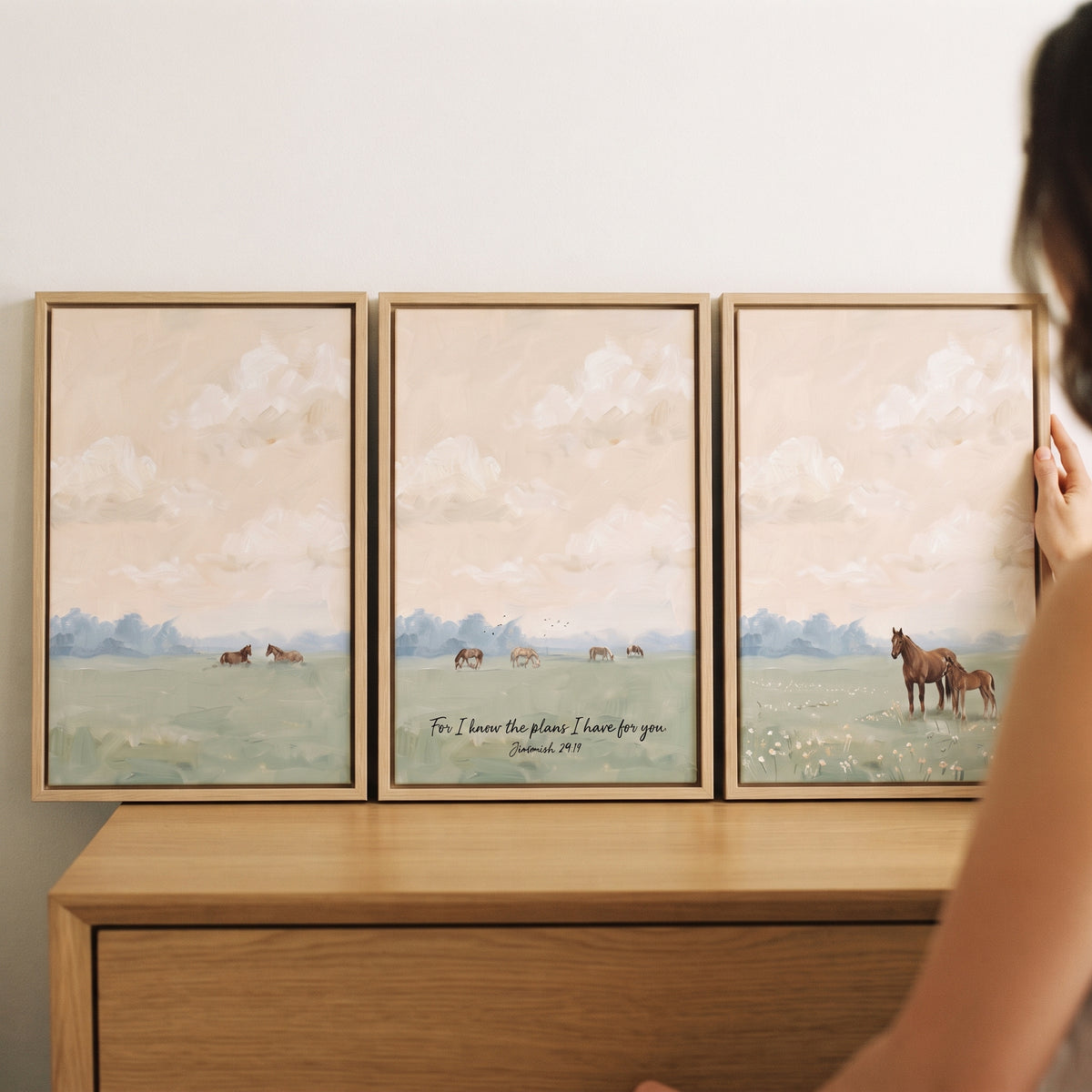 Warm sunset landscape horses wall art set of 3 depicts peaceful fields, grazing animals, and scripture on a wooden dresser.