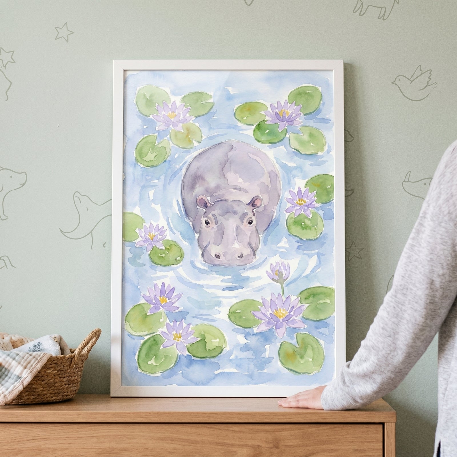 Framed water lily hippo wall art features a watercolor hippo floating among purple lilies and green lily pads.