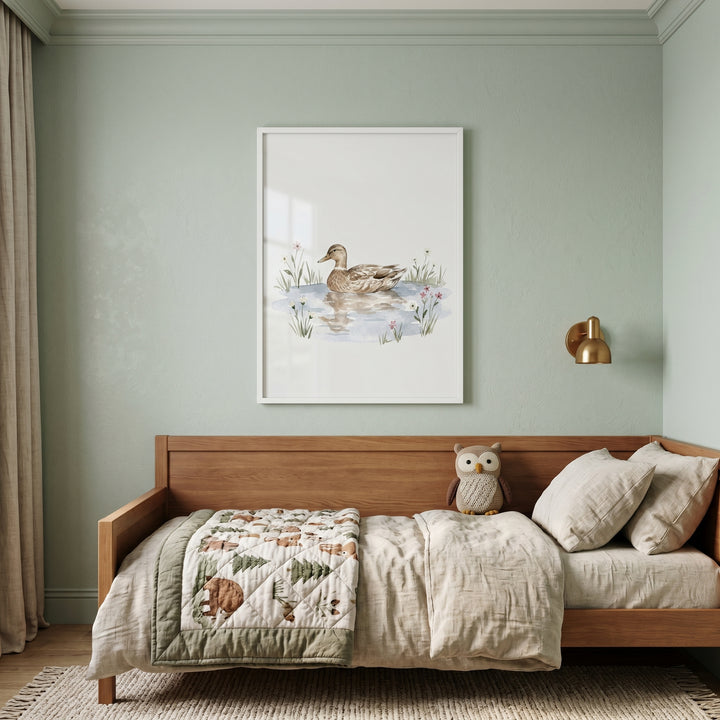 Water reflection mallard duck wall art hangs above a wooden bed with a bear quilt and owl toy in a sage green room.