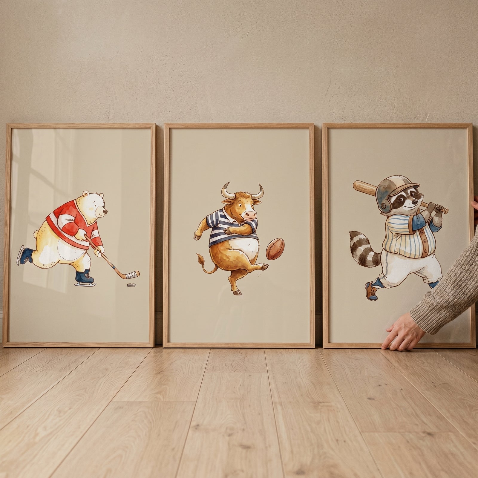 Watercolor action sports animals wall art set of 3 featuring a hockey bear, rugby bull, and baseball raccoon in frames.