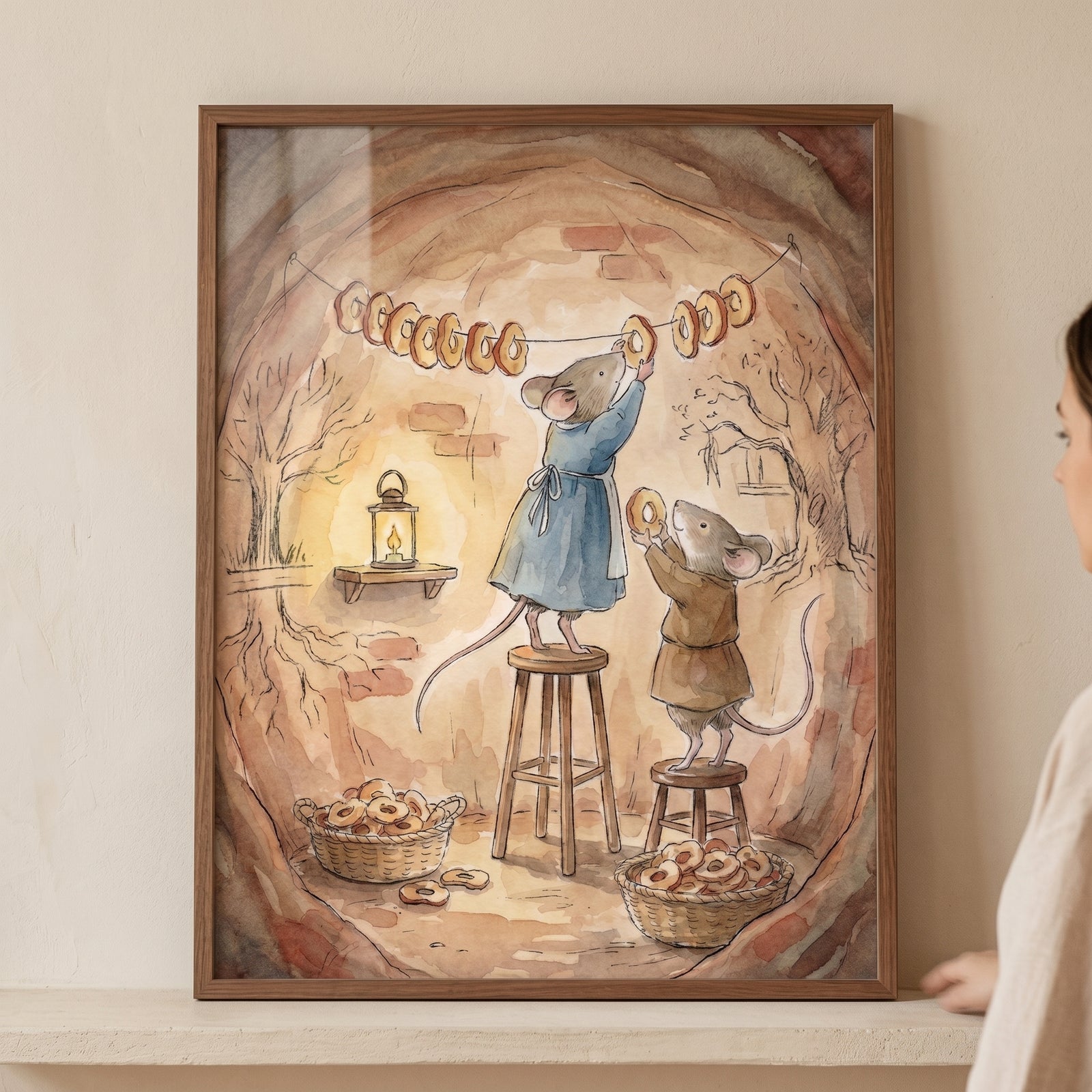 Mice hang ring-shaped treats in a cozy burrow. Watercolor baking mouse wall art with stools and baskets of baked goods.