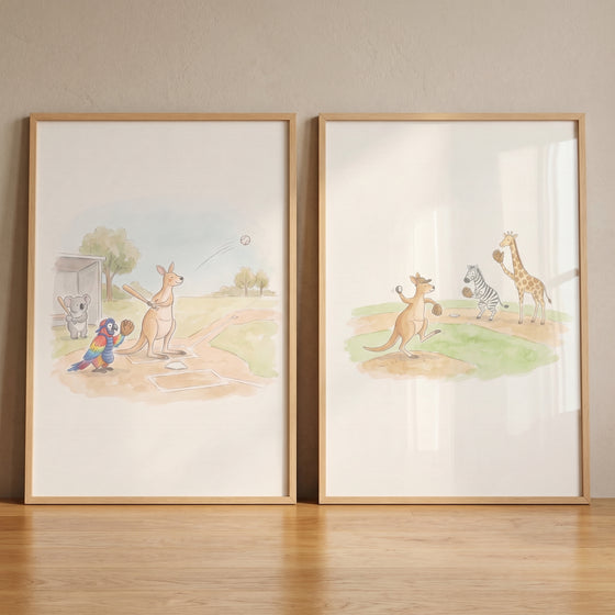 Framed watercolor baseball safari animal wall art set of 2 featuring a kangaroo, zebra, and giraffe playing ball.