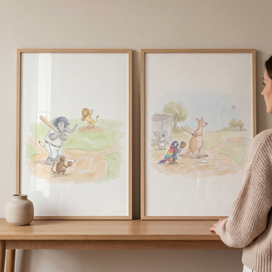 Framed watercolor baseball safari animals wall art set of 2 featuring an elephant batting and a kangaroo playing ball.
