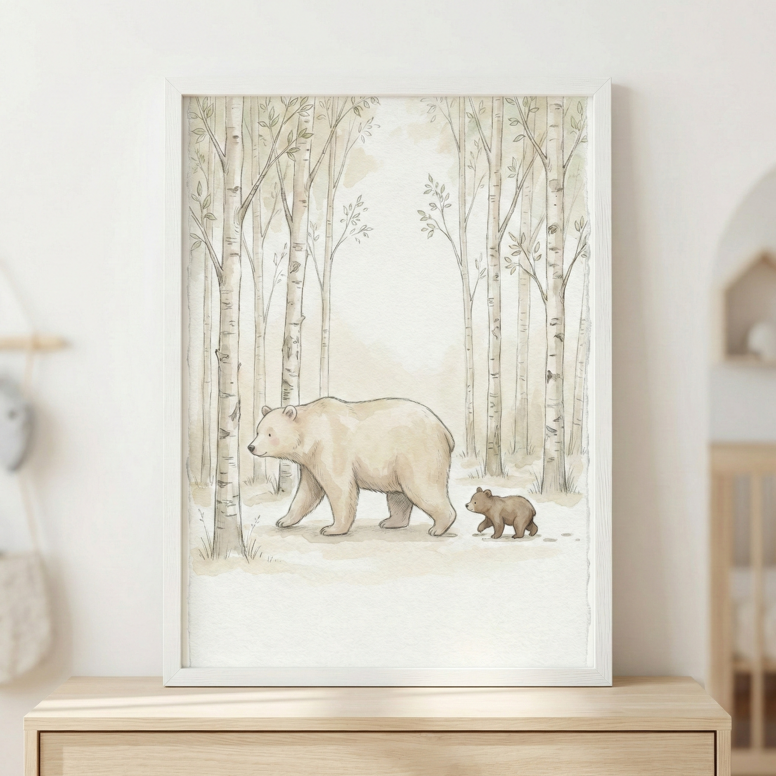 A soft-toned watercolor-style illustration features a large bear and its small cub walking through a forest. Both bears are rendered in gentle shades of beige and light brown. They travel across a pale ground past tall, slender trees with light-colored bark and delicate leaves. The muted, neutral color palette creates a peaceful atmosphere. This artwork is displayed in a thin white frame, resting on a light-colored wooden dresser against a plain wall.