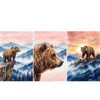  Three watercolor paintings of brown bears in misty mountain landscapes beneath warm pink skies. One shows a bear standing on a rocky cliff above a forest filled valley with birds flying overhead, the center shows a close side profile portrait of a brown bear against distant blue mountains, and the third shows a bear walking along a mountain ridge glowing in golden sunset light.

