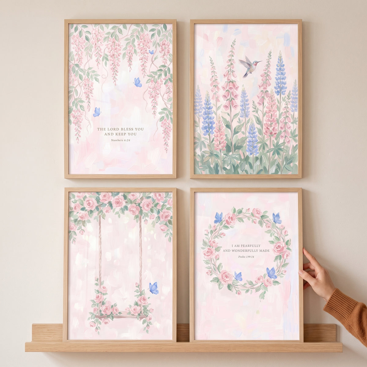 Watercolor blush blue garden wall art set of 4 featuring flowers, butterflies, and scripture in wood frames on a shelf.