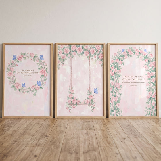 Watercolor butterfly pink rose wall art set of 3 with Bible verses in wood frames leaning on a wooden floor.