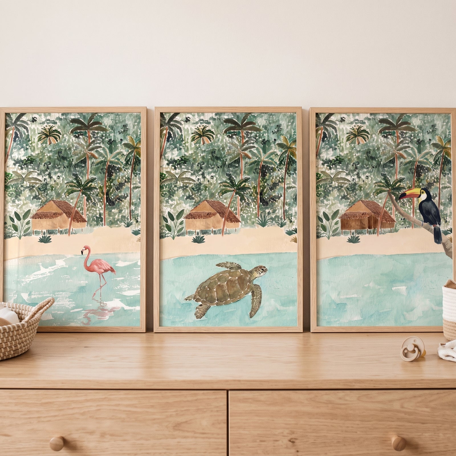 Watercolor coastal jungle animals wall art set of 3 featuring a flamingo, sea turtle, and toucan in beach settings.