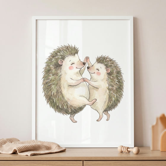 Watercolor dancing hedgehog wall art features two smiling hedgehogs holding hands and dancing in a white frame.