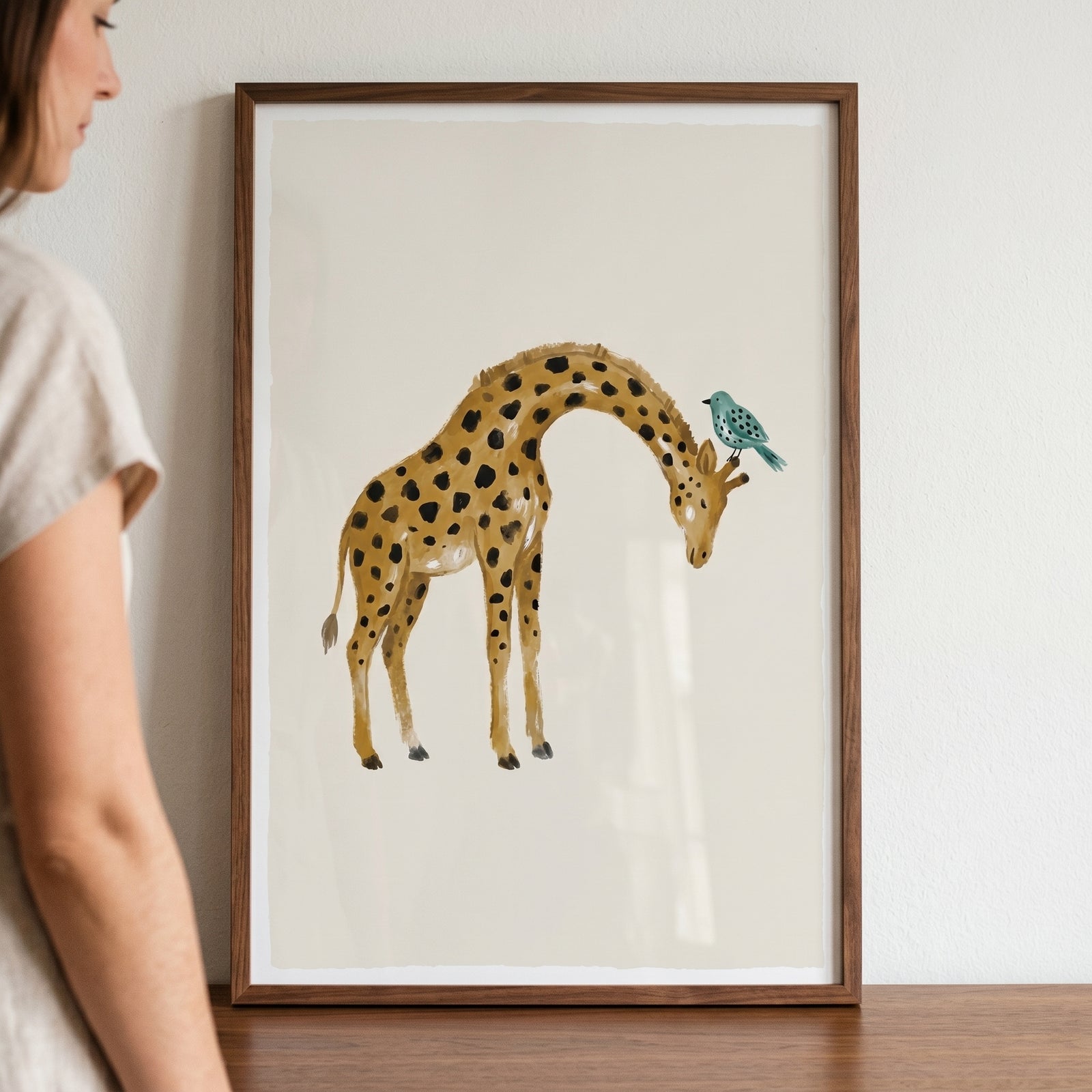 Watercolor earth tone giraffe wall art featuring a giraffe with a small teal bird perched on its head.