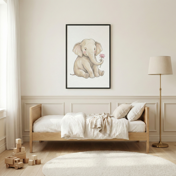 A serene child's bedroom featuring a light wood bed with white bedding and a cream-colored throw. Above the bed, a black frame holds a watercolor-style illustration of a sitting baby elephant holding a pink flower in its trunk. To the right of the bed stands a gold floor lamp with a cream shade. On the light wood floor, there is a round white rug and a collection of wooden toy blocks and a wooden toy truck. The room is decorated in a soft cream color with white curtains on the left.