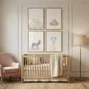 A cozy nursery features a wooden crib with a knit blanket beneath four framed watercolor prints of a lamb goat donkey and a llama wearing a flower crown. The soft neutral decor and gentle farm animal artwork create a calm soothing space for a baby room.