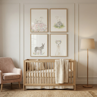 A cozy nursery features a wooden crib with a knit blanket beneath four framed watercolor prints of a lamb goat donkey and a llama wearing a flower crown. The soft neutral decor and gentle farm animal artwork create a calm soothing space for a baby room.