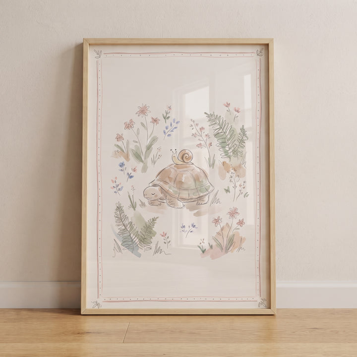 Watercolor floral garden turtle wall art in a wood frame featuring a turtle and snail amidst soft pastel flowers and ferns.