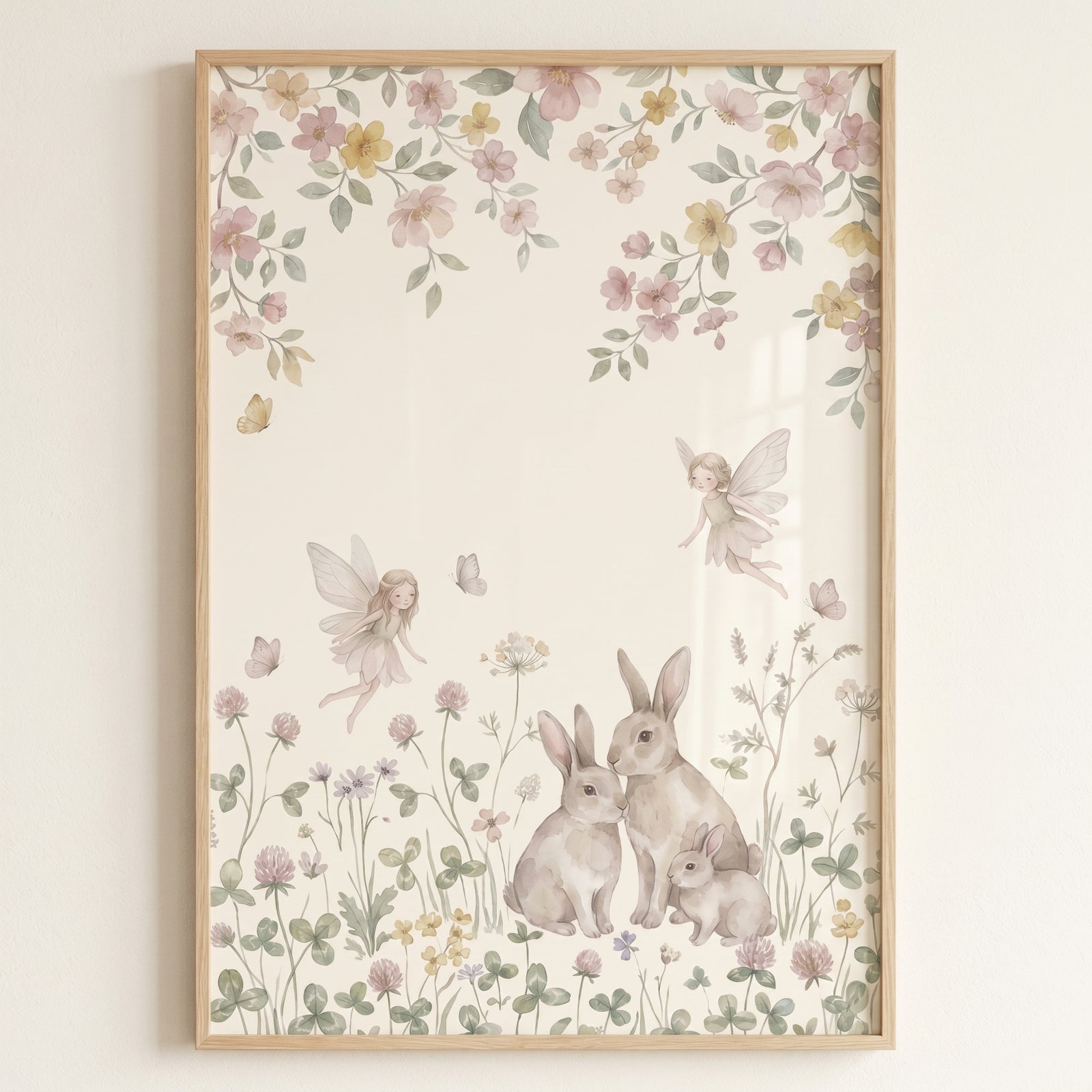 Watercolor floral meadow bunnies wall art depicts two flying fairies and three rabbits among soft pastel wildflowers.