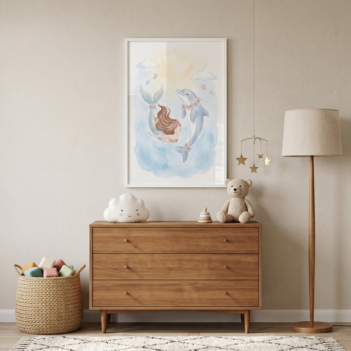 Watercolor floral mermaid dolphin wall art hangs above a wooden dresser styled with a teddy bear and cloud lamp.