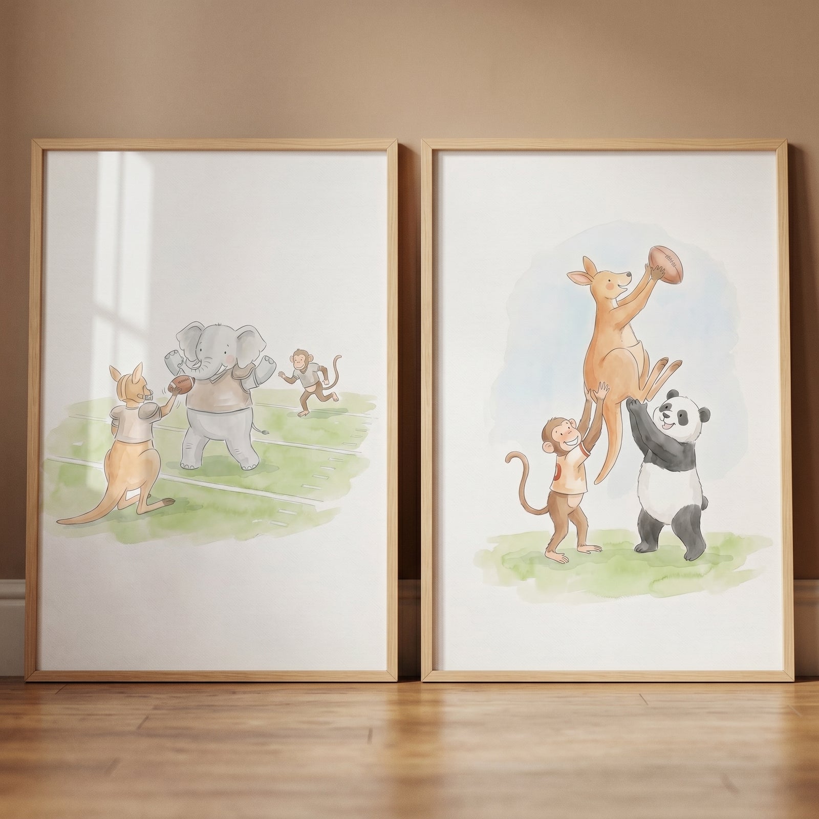 Watercolor football animal wall art set of 2 with a panda, elephant, monkey, and kangaroo playing in wood frames.