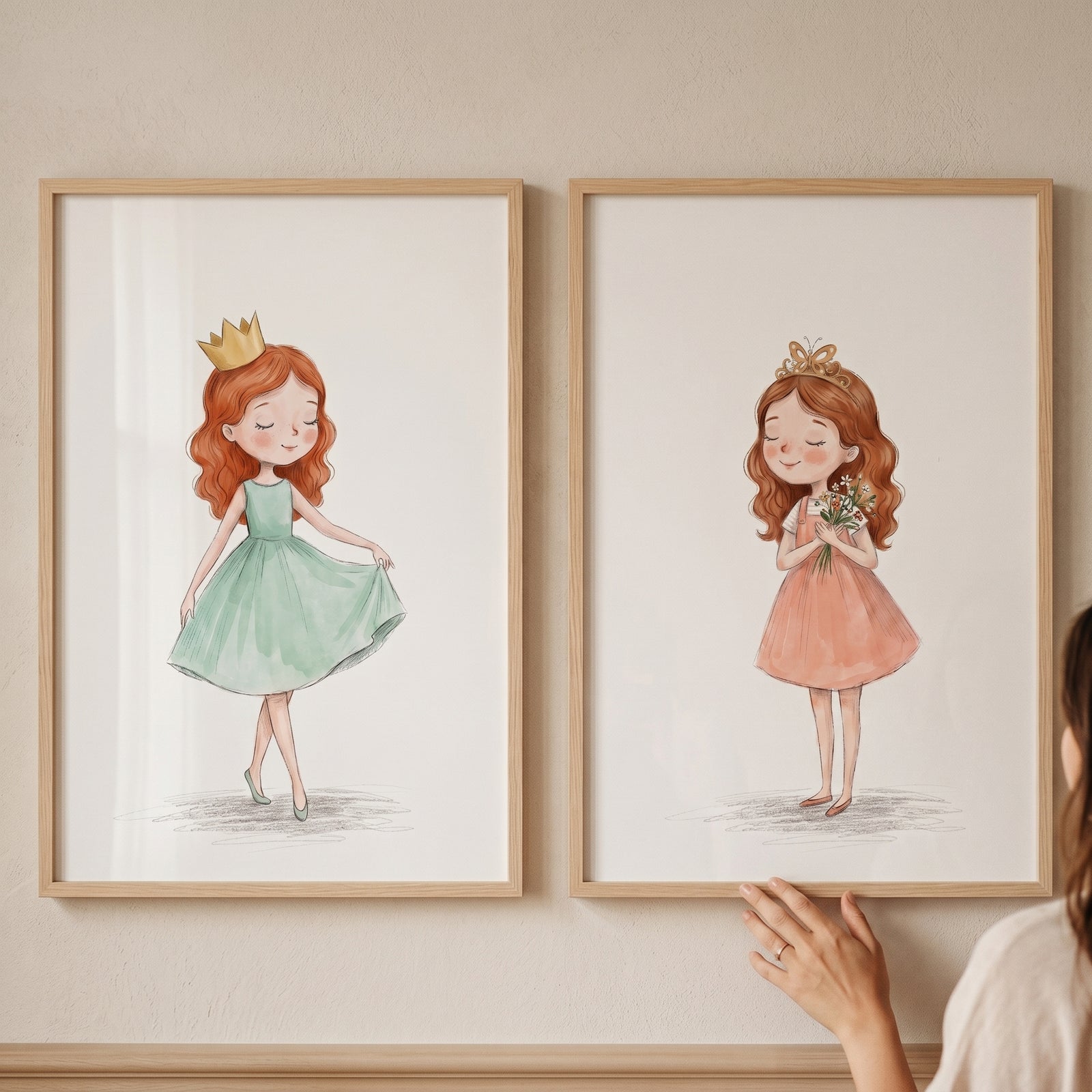 Watercolor golden crown princess wall art set of 2 features two framed illustrations of girls in colorful dresses.