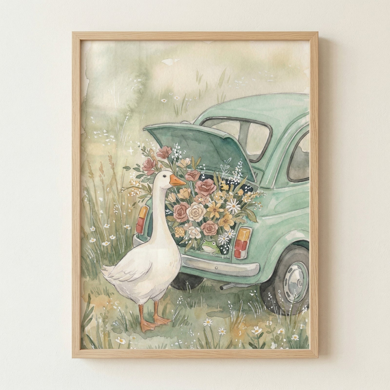 A soft, whimsical watercolor-style illustration depicts a white goose standing in a lush, grassy field next to a small, vintage light-green car. The car's rear hatch is propped open, overflowing with a large, colorful bouquet of flowers in shades of pink, yellow, and white. A tiny green frog can be seen peeking out from the bottom of the flower arrangement. 