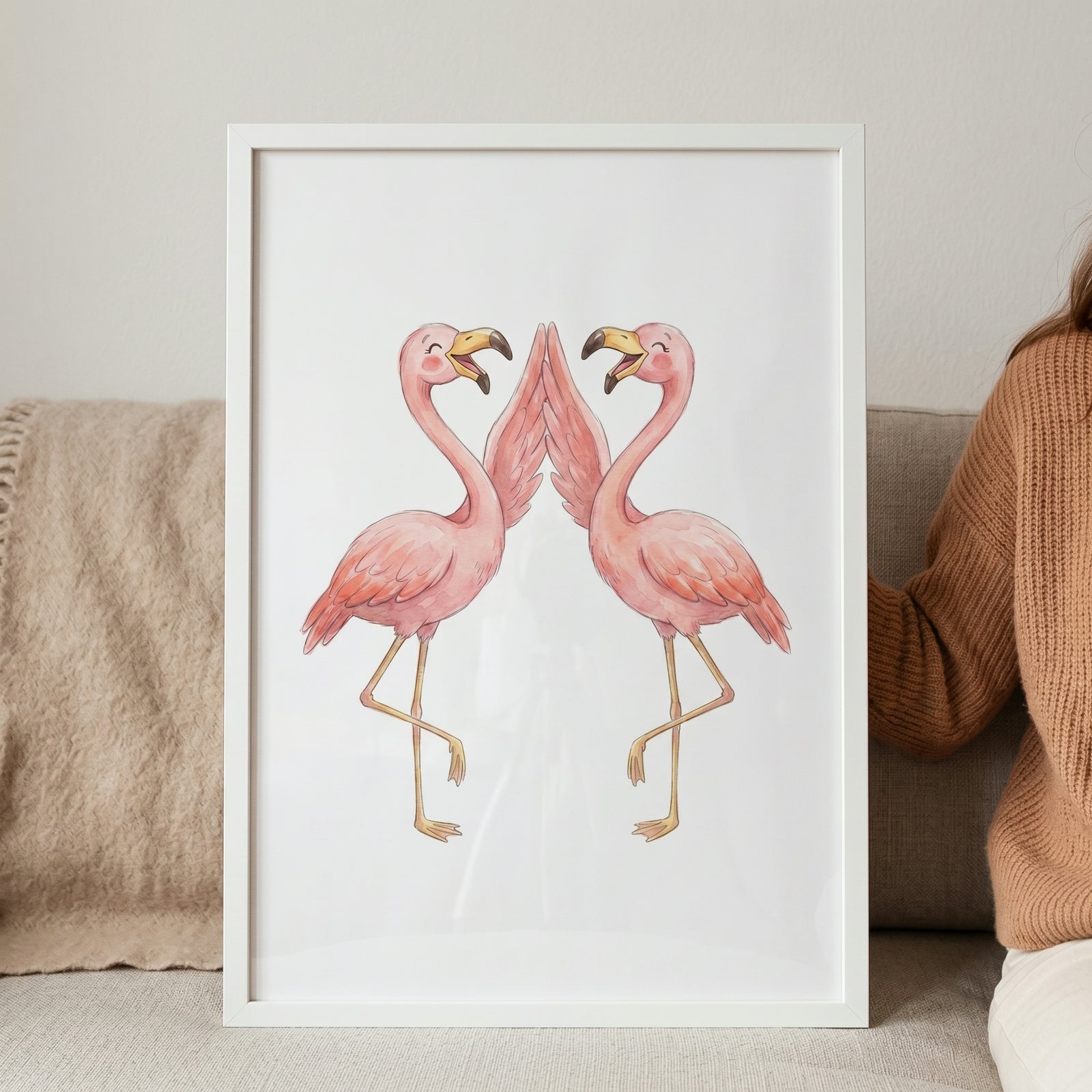 Two smiling pink flamingos touch wings in this watercolor high five flamingo wall art displayed in a white frame.