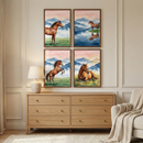 A well-lit interior scene features a wooden dresser with six drawers, each adorned with a simple round knob. Above the dresser, four framed art pieces are arranged in a two-by-two grid on a light beige wall with elegant panel molding. Each piece of art depicts a brown horse in a different pose, set against a watercolor-style background of hazy blue mountains and a soft sunset sky with small birds in flight. 
