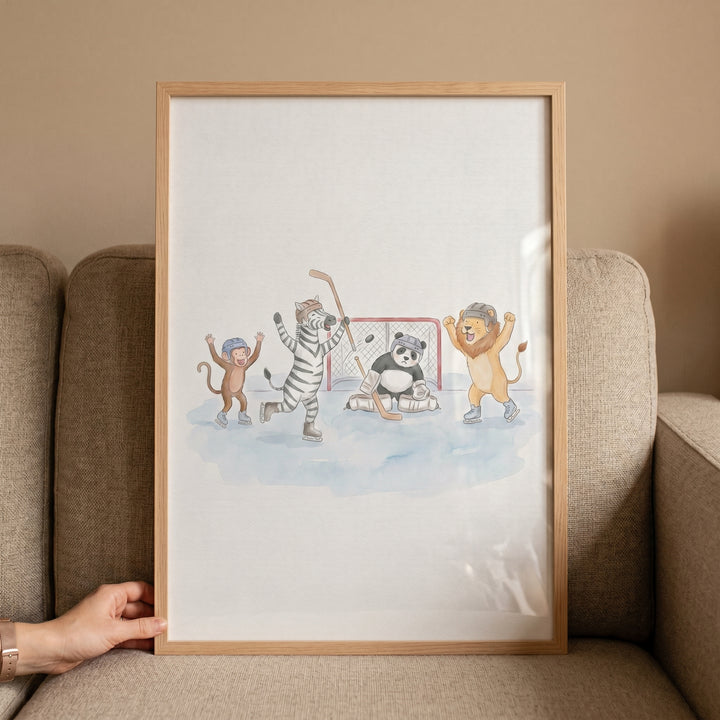 Framed watercolor ice hockey animals wall art featuring a monkey, zebra, panda goalie, and lion on a rink.