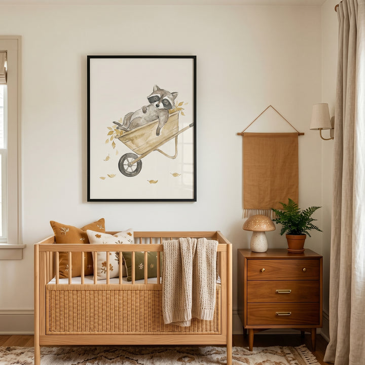 Watercolor leaf wheelbarrow raccoon wall art hangs above a wooden crib in a neutral nursery with a mushroom lamp.