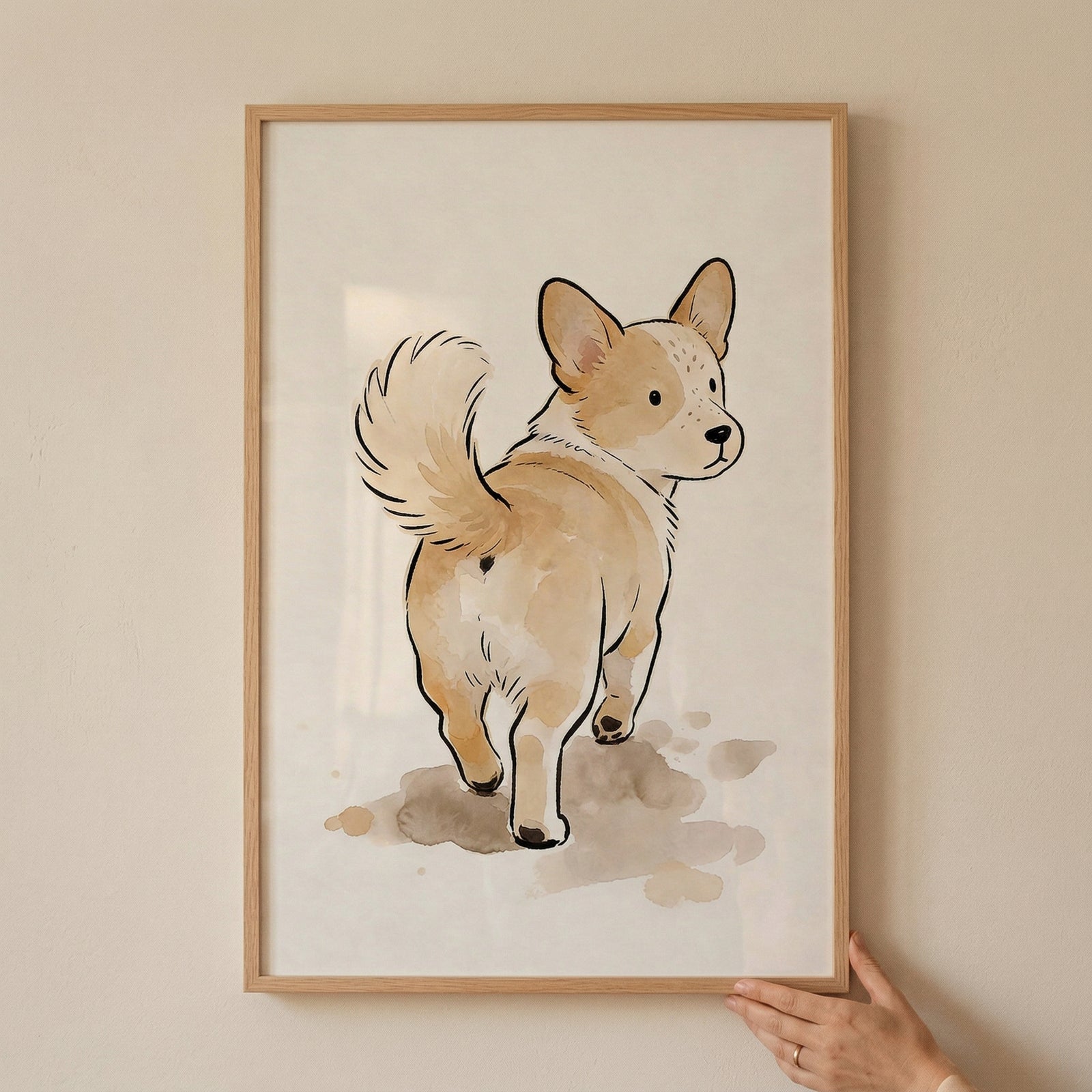 A framed illustration of a small, tan and white dog with short legs and a fluffy, curled tail. The dog is shown from behind, turning its head to look back over its shoulder with large, dark eyes and pointed ears. The artwork is composed of clean black ink outlines and soft, light brown washes for color. 