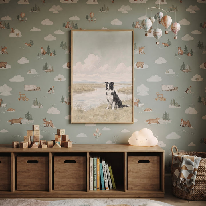 Watercolor marsh border collie dog wall art hangs in a nursery with animal wallpaper and a wooden toy shelf.