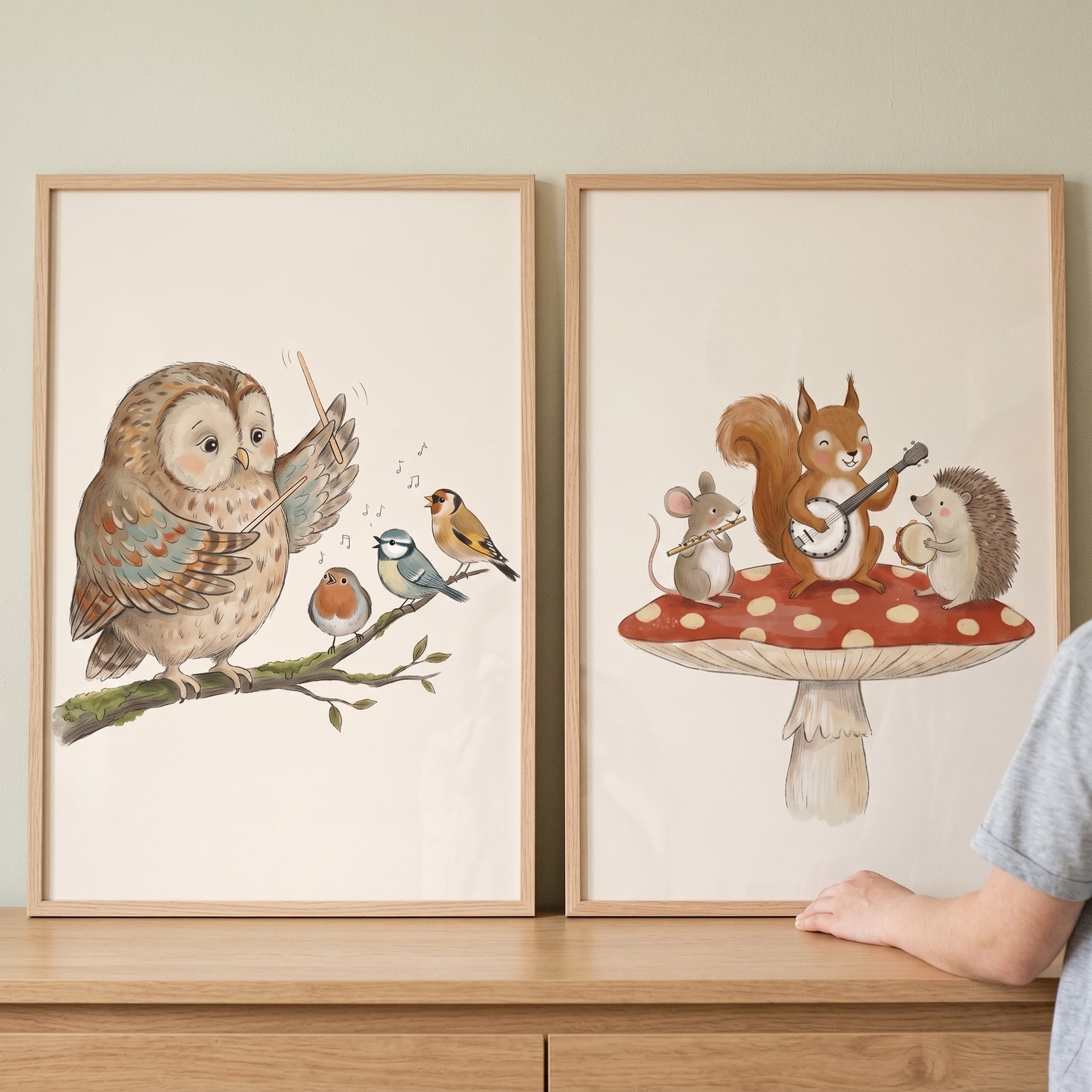Watercolor musical woodland animals wall art set of 2 shows an owl conducting birds and forest animals playing on a mushroom.