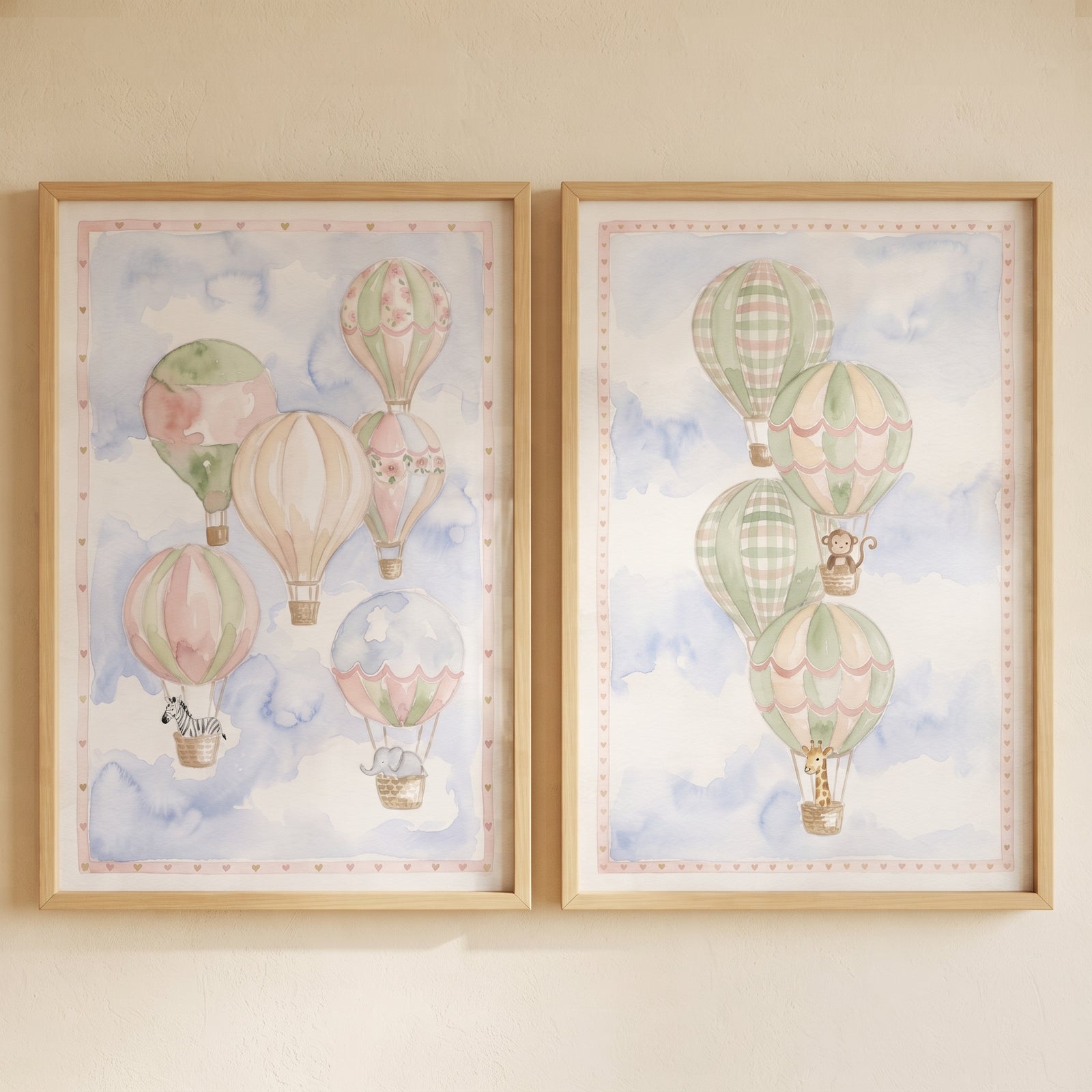 Watercolor pastel sky balloon wall art set of 2 featuring hot air balloons and animals in light wood frames.