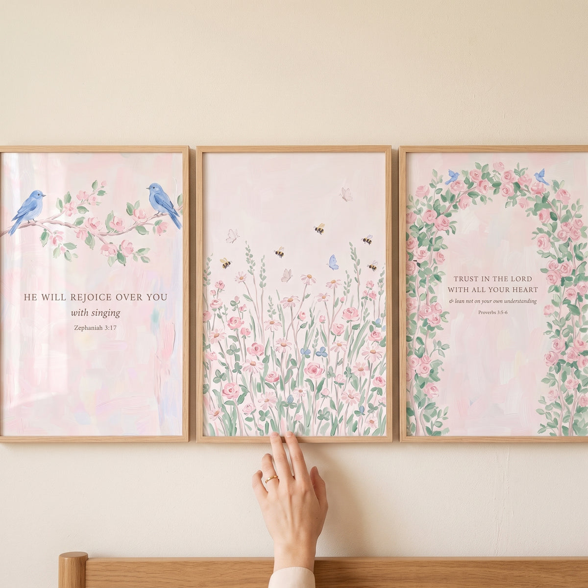 Watercolor pink garden scripture print set of 3 hanging on a wall featuring birds, flowers, and Bible verses.
