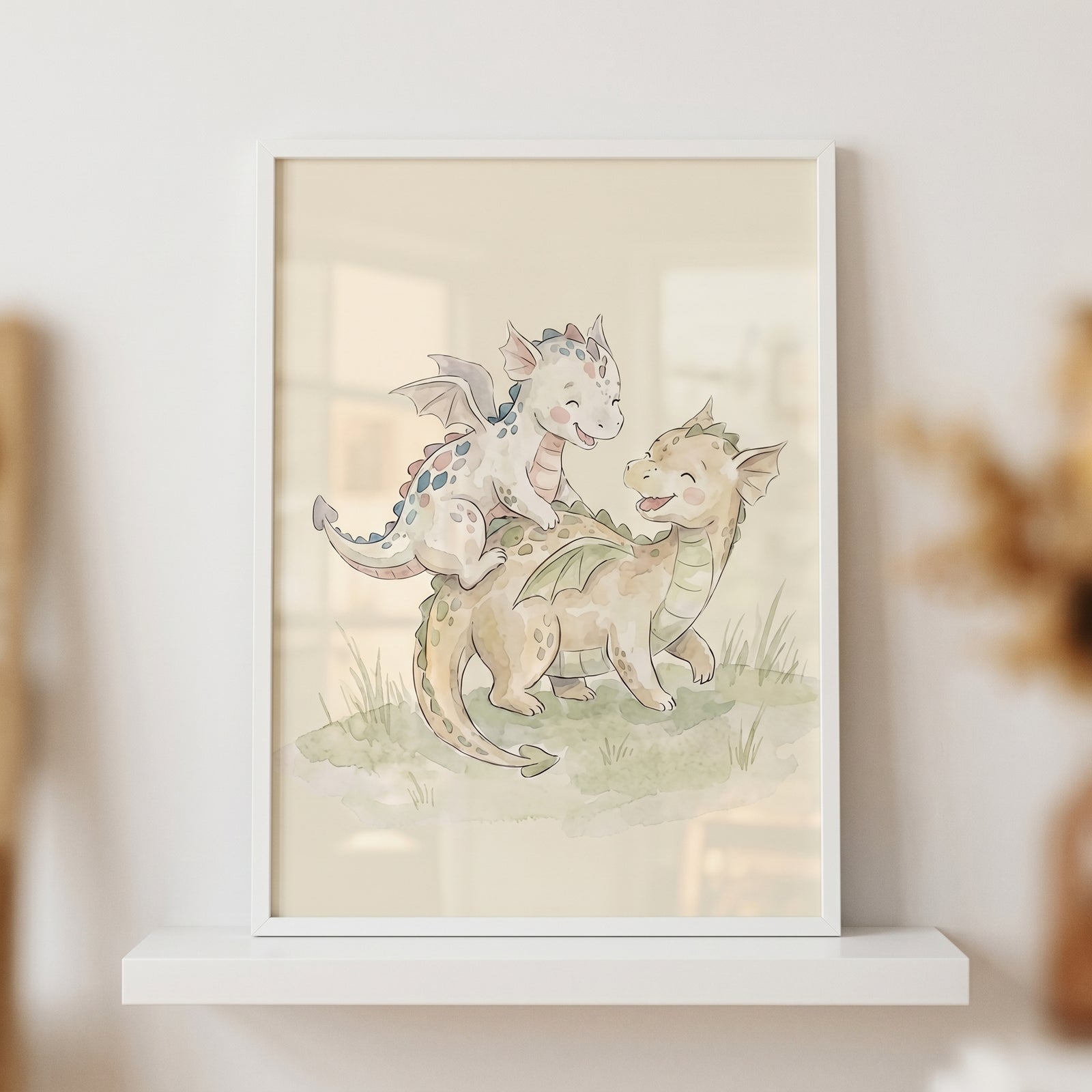 Watercolor playing baby dragons wall art featuring two small, smiling dragons in a white frame on a shelf.