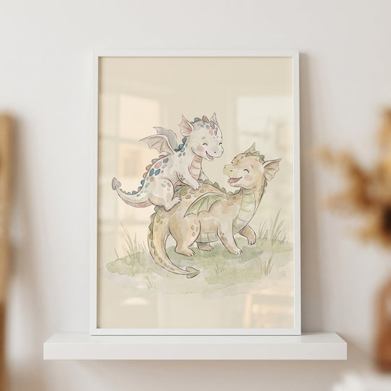 Watercolor playing baby dragons wall art featuring two small, smiling dragons in a white frame on a shelf.
