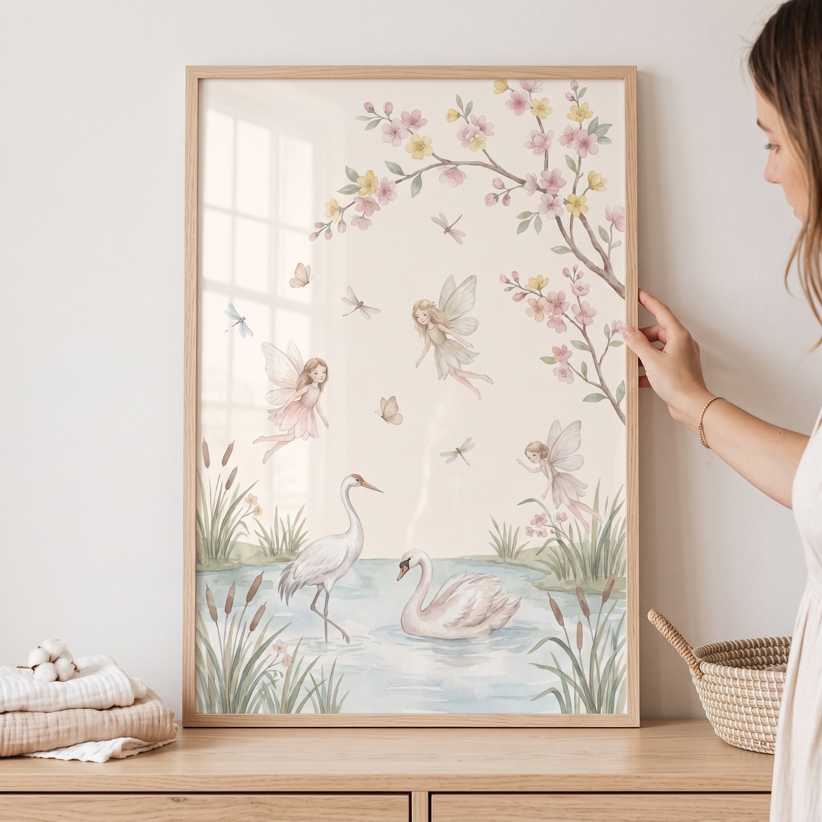 Framed watercolor pond whimsical fairies wall art featuring a swan, crane, and flying fairies near blossoming branches.