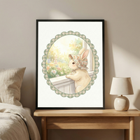 This image showcases a framed illustration of a small, cream-colored rabbit wearing a dainty, floral-patterned bonnet. The rabbit is perched at a window, gazing out onto a sunlit landscape filled with colorful wildflowers. The entire scene is enclosed within a scalloped, oval-shaped border that features a green and white gingham pattern.


