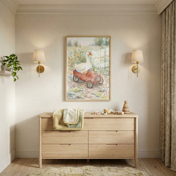 A serene and neutrally-toned nursery features a vertical framed work of art centered on a light-colored wall. The art is a soft watercolor illustration of a white goose and a small yellow chick sitting inside a red, vintage-style toy car in a meadow. On either side of the art, there are brass wall sconces with simple, cream-colored fabric shades.
