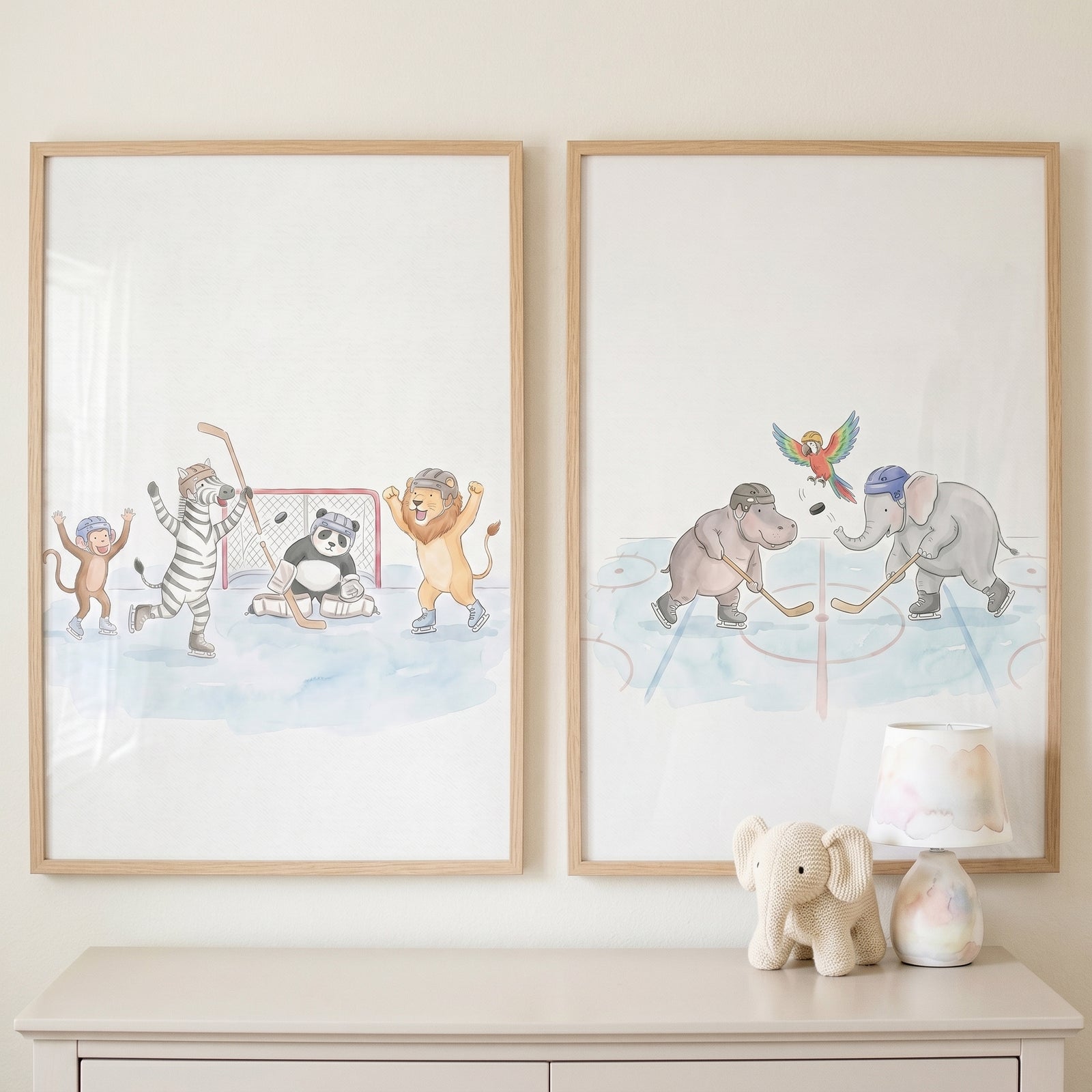 Watercolor rink hockey animals wall art set of 2 depicts animals playing ice hockey above a dresser with a knit toy.