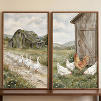 Geese walk toward a barn and chickens peck near a shed in this watercolor rustic farm animal wall art set of 2.