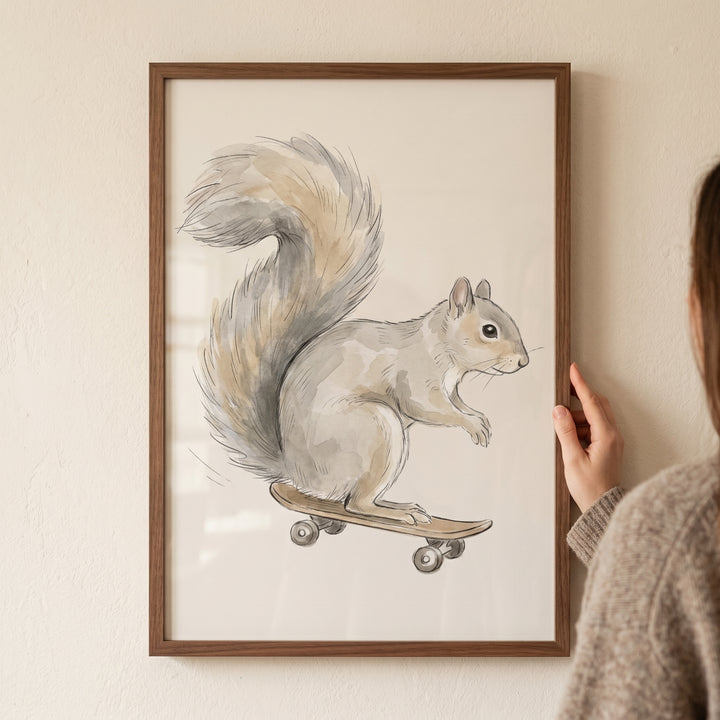 Framed watercolor skateboard squirrel wall art held by a person against a light beige wall.