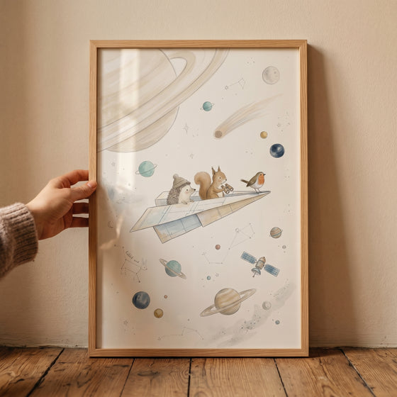 Framed watercolor space paper airplane wall art shows woodland animals on a paper plane flying past planets and stars.