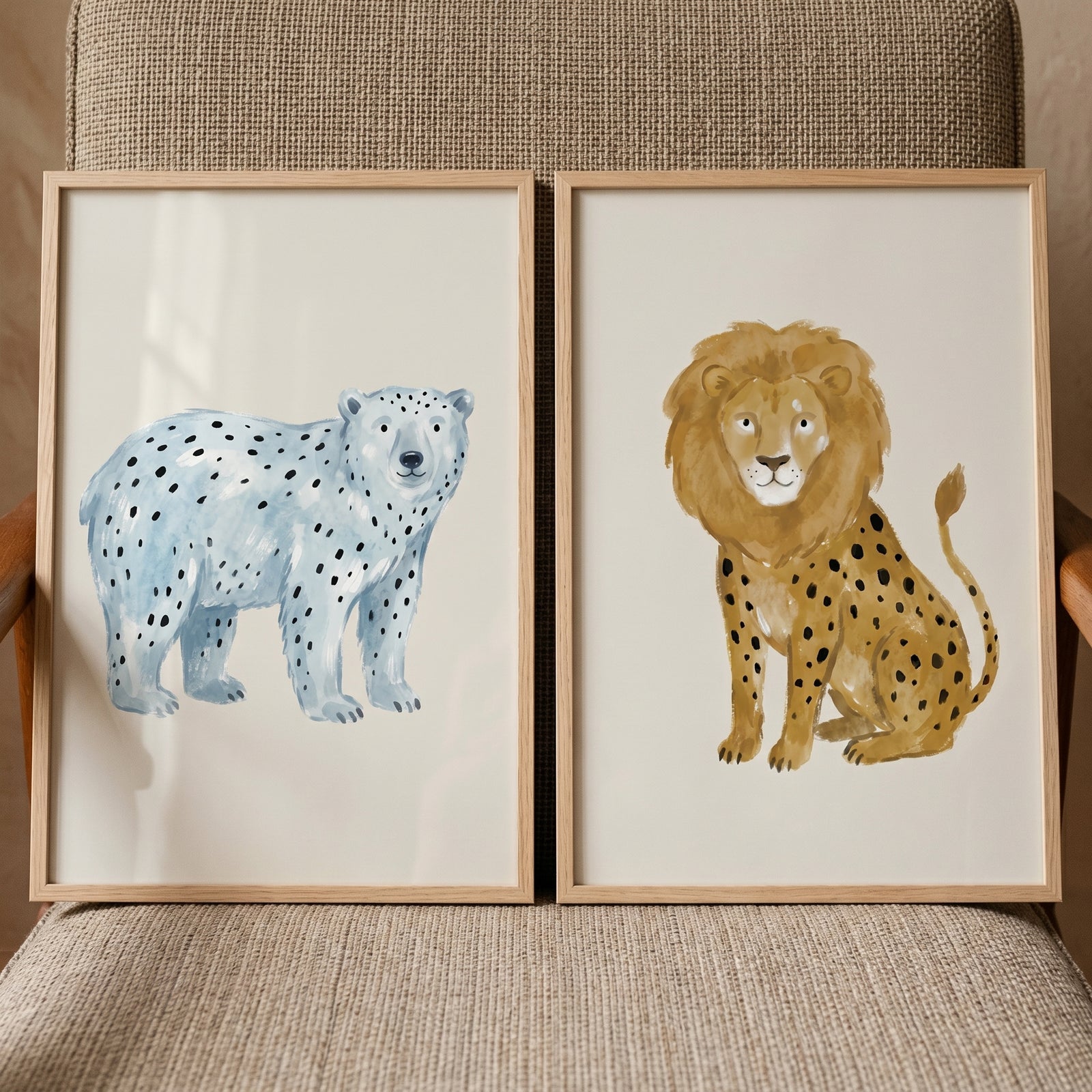 Watercolor spotted animals wall art set of 2 featuring a blue bear and a brown lion with spots in light wood frames.