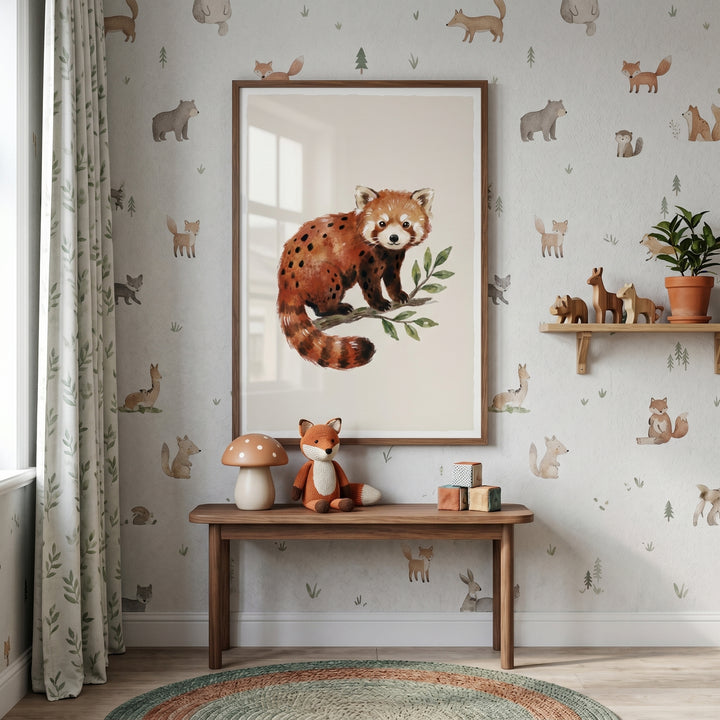 Framed watercolor spotted red panda wall art hangs in a nursery with forest animal wallpaper and a wooden bench.